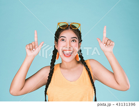 Portrait of a fitness woman pointing fingers up Portrait of a fitness woman pointing fingers up 43131396