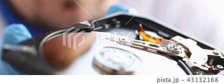 A male repairman wearing blue gloves 43132168