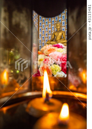 Lighten candles and flowers to worship Buddha Lighten candles and flowers to worship Buddha 43133481
