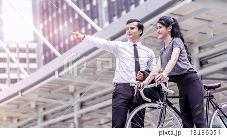 Businessman direction for a bicycle woman Businessman direction for a bicycle woman 43136054