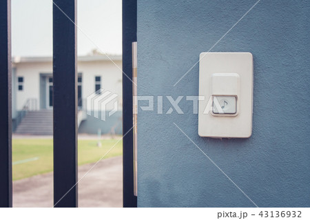 White doorbell or buzzer button on concrete wall. White doorbell or buzzer button on concrete wall. 43136932