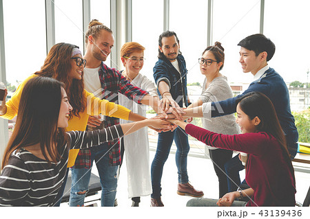 Multiethnic young team stack hands together 43139436