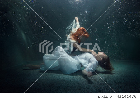 Two young women under the water. Two young women under the water. 43141476