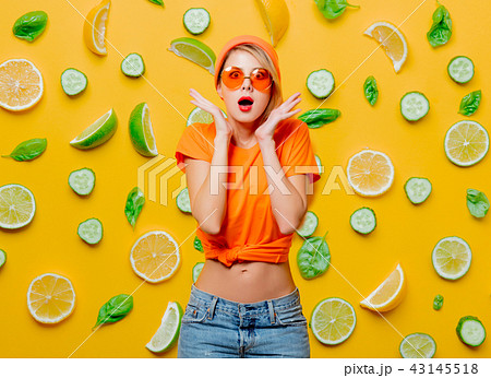 girl with orange glasses on fruit background girl with orange glasses on fruit background 43145518