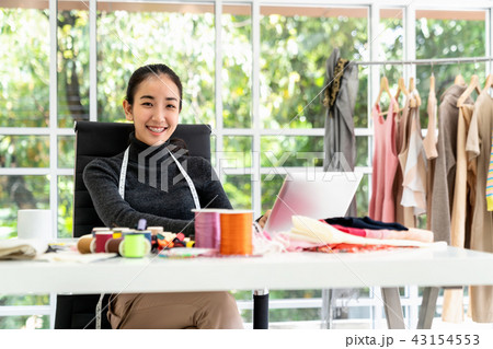 Happy asian smart looking fashion designer 43154553