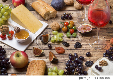 Cheese, wine, baguette grapes figs honey and snack 43160300