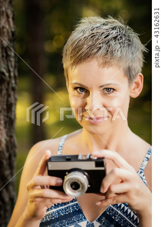 portrait of a beautiful woman with a camera in a summer forest portrait of a beautiful woman with a camera in a summer forest 43162631
