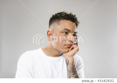 Beautiful bored man bored isolated on gray background 43162632