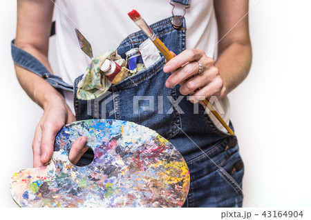 girl painter holds a brush 43164904