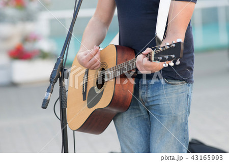 Anonymous man playing guitar on the street, street musician Anonymous man playing guitar on the street, street musician 43165993