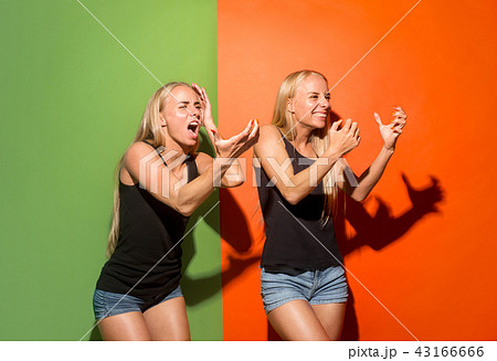 The young emotional angry women screaming on studio background 43166666