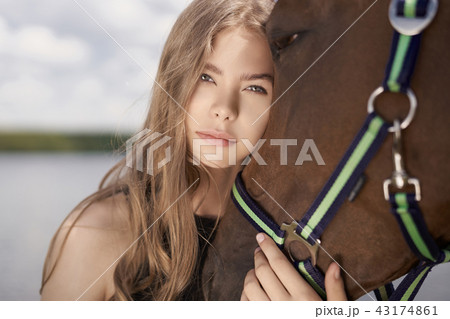 Beautiful young lady with horse 43174861