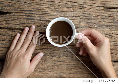 holding cup of coffee holding cup of coffee 43177592