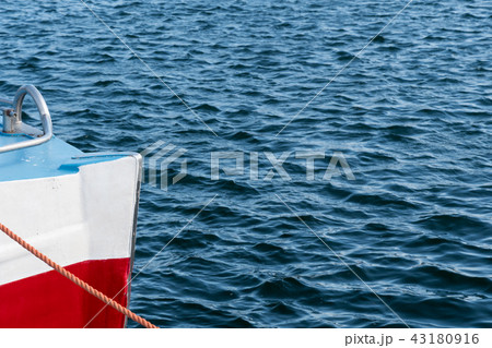Colorful bow of a boat in rippled water Colorful bow of a boat in rippled water 43180916