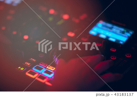 Dj mixes the track in the nightclub at party. DJ hands in motion Dj mixes the track in the nightclub at party. DJ hands in motion 43183137