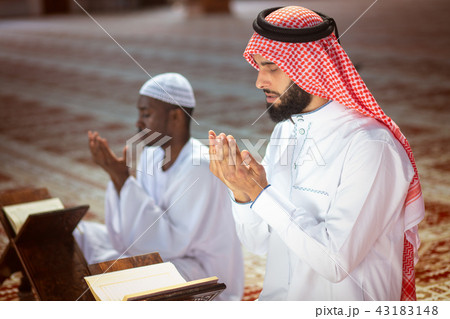 Two religious muslim man praying together inside the mosque 43183148