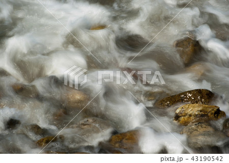 Soft waves on a rocky beach in the morning 43190542
