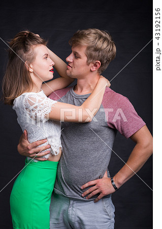 Lovers kissing each other on black background Lovers kissing each other on black background 43192156