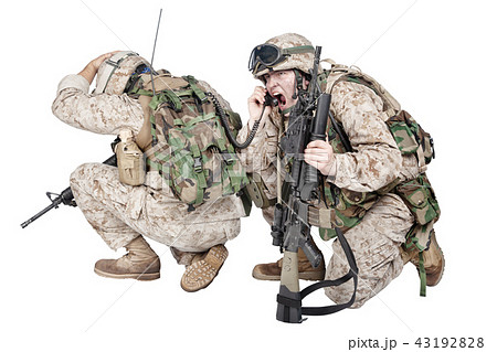 Soldier talking on radio under fire studio shoot Soldier talking on radio under fire studio shoot 43192828