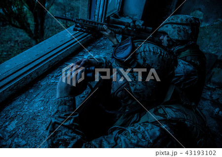 Army sniper team shooting with large caliber rifle 43193102