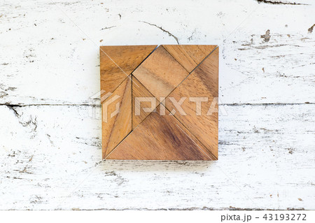 Tangram puzzle in square shape on white wood 43193272