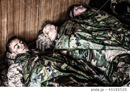 Tired soldiers sleeping on floor at temporary base Tired soldiers sleeping on floor at temporary base 43193520