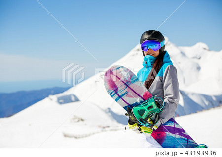 Photo of woman hiking helmet with snowboard on snow mountains background Photo of woman hiking helmet with snowboard on snow mountains background 43193936