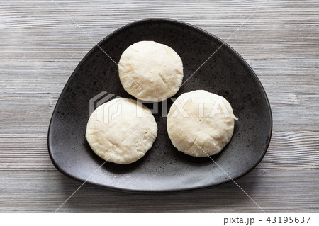 Idli Sambar dumplings on black plate on table Idli Sambar dumplings on black plate on table 43195637