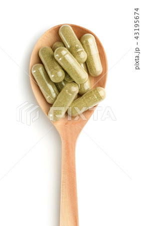 Wooden spoon full of herbal capsules Wooden spoon full of herbal capsules 43195674