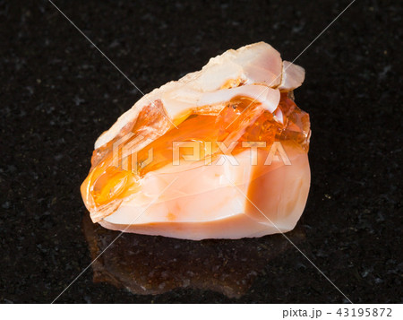 raw precious opal and fire opal gem stone on black 43195872