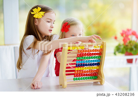 Cute little girl playing with abacus at home 43208236