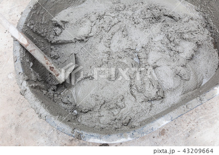Mixed mortar cement in container ready to be used Mixed mortar cement in container ready to be used 43209664