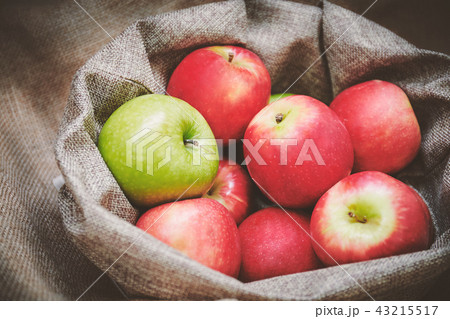 Red and green apples in the bowl cover with burlap Red and green apples in the bowl cover with burlap 43215517