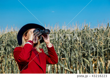 Young girl in coat with binoculars  43216223