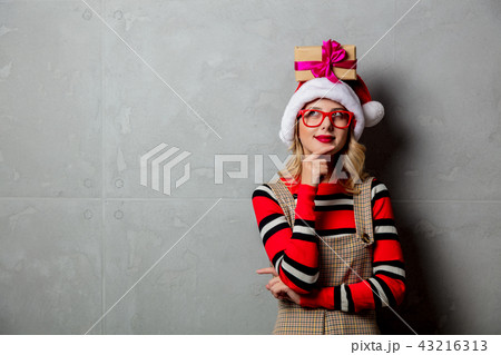 Young girl with Christmas gift box over head Young girl with Christmas gift box over head 43216313