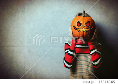 girl in red striped sweater with halloween pumpkin girl in red striped sweater with halloween pumpkin 43216385