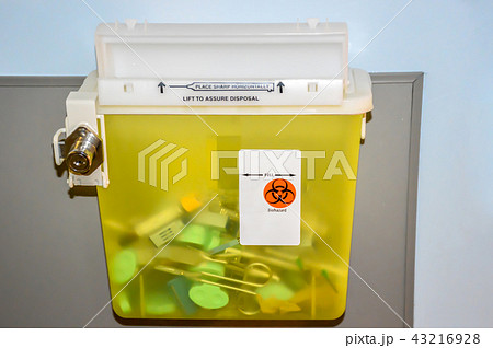 Photo of a locked yellow sharps container with use Photo of a locked yellow sharps container with use 43216928