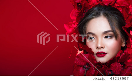 Asian tanned skin woman with strong color red lips Asian tanned skin woman with strong color red lips 43218997