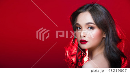 Asian tanned skin woman with strong color red lips Asian tanned skin woman with strong color red lips 43219007