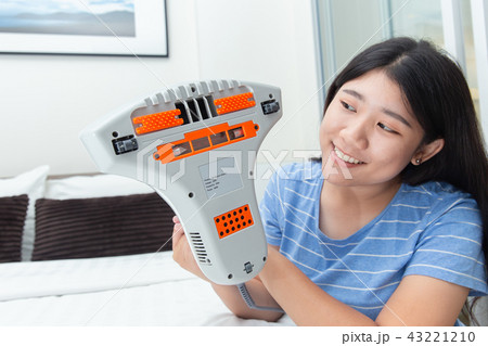 Girl using mite vacuum cleaner using cleaning Girl using mite vacuum cleaner using cleaning 43221210