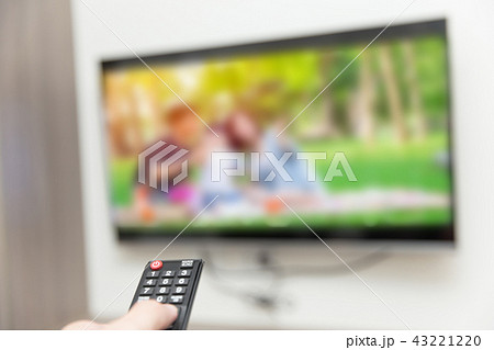 people watching tv hand with remote control 43221220