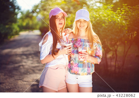 Trendy two women with drinks Trendy two women with drinks 43228062