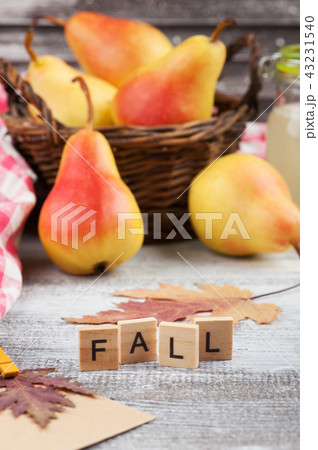 Basket with pears on wooden table Basket with pears on wooden table 43231540