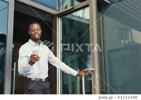 Portrait of a confident young black businessman talking on cell Portrait of a confident young black businessman talking on cell 43232390