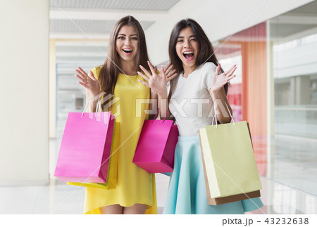 Surprised woman with shopping bags in mall Surprised woman with shopping bags in mall 43232638