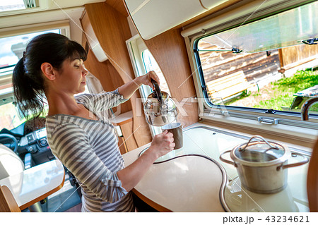 Woman cooking in camper, motorhome interior Woman cooking in camper, motorhome interior 43234621