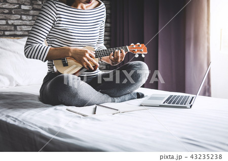 Young happiness woman on bedroom in enjoying playing the music w 43235238