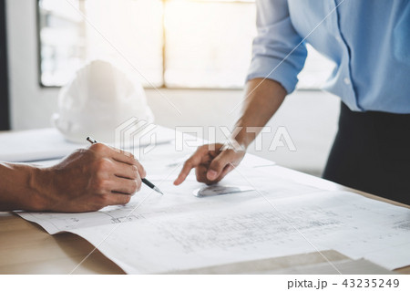 Hands of architect or engineer working on blueprint meeting for Hands of architect or engineer working on blueprint meeting for 43235249