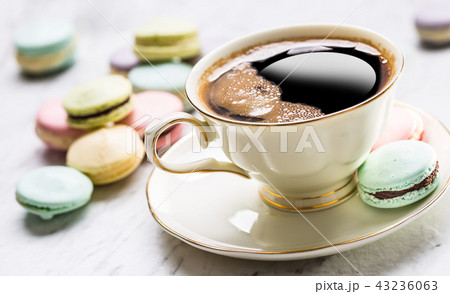 Cake from marzipan flowers macaroons and coffee. Cake from marzipan flowers macaroons and coffee. 43236063