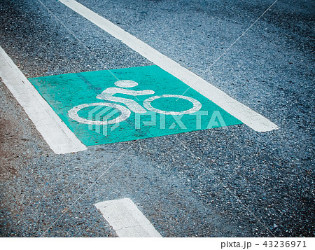 Green bicycle lane painted symbol on the road  43236971
